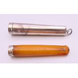 A silver cigarette holder case, containing a silver mounted amber cigarette holder. 7 cm long. 16.