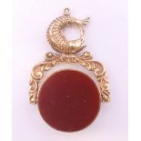 A 9 ct gold bloodstone and carnelian swing fob set with fish. 4 cm high. 12.3 grammes total weight.