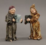 A pair of 19th century Continental porcelain monks, each holding a tankard. The largest 17 cm high.
