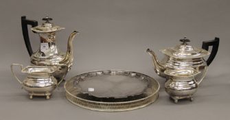 A silver plated tea set and two silver plated trays. The teapot 16 cm high.