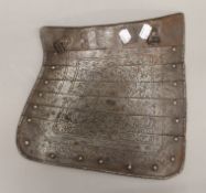 An engraved armour tasset. 30.5 cm high.