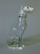 A silver plate mounted glass claret jug formed as a dog. 24 cm high.