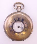 A silver half hunter pocket watch by Dennison. 5 cm diameter.