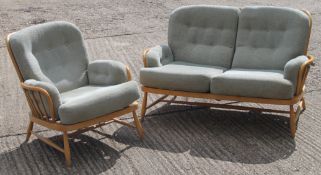 An Ercol blonde oak two seater settee and matching armchair. The former 141 cm wide.