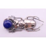 A silver lapis set beetle brooch. 5.5 cm long.