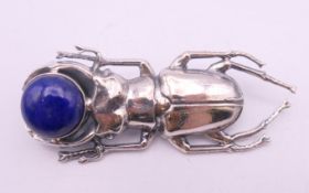 A silver lapis set beetle brooch. 5.5 cm long.