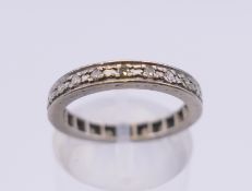 An 18 ct white gold diamond set eternity ring. Ring size K/L. 3.3 grammes total weight.