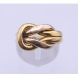 A Cartier 18K gold knot ring, with box and certificate. Ring size G/H. 9.5 grams.