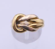 A Cartier 18K gold knot ring, with box and certificate. Ring size G/H. 9.5 grams.