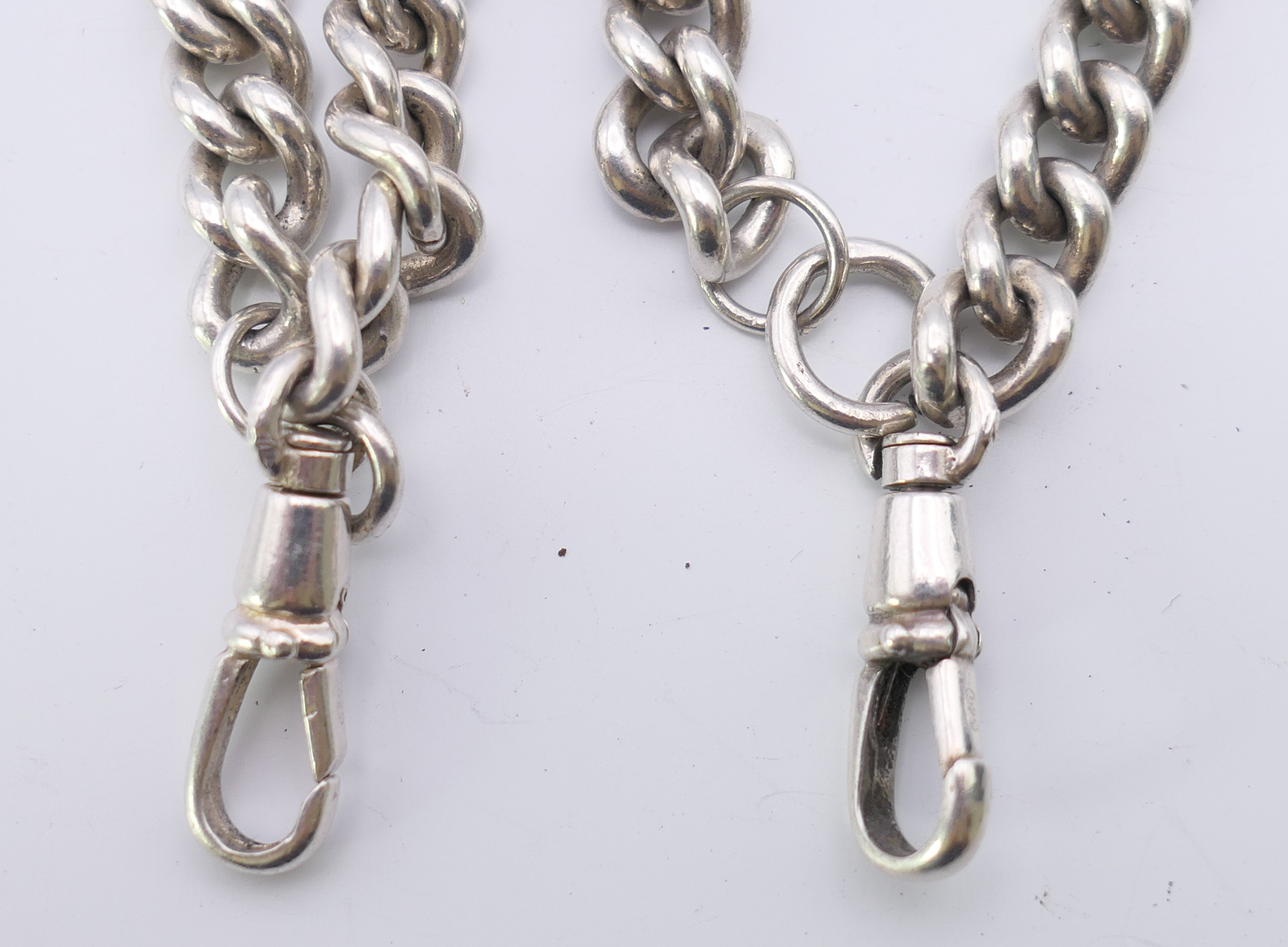 A silver curb link double Albert watch chain. 54.5 cm long. 145.5 grammes. - Image 4 of 5