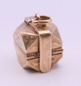 A 9 ct gold folding box form locket pendant. 1.5 cm wide. 12.8 grammes.