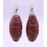 A pair of Chinese carved figural earrings. 3.25 cm high.