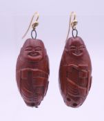 A pair of Chinese carved figural earrings. 3.25 cm high.
