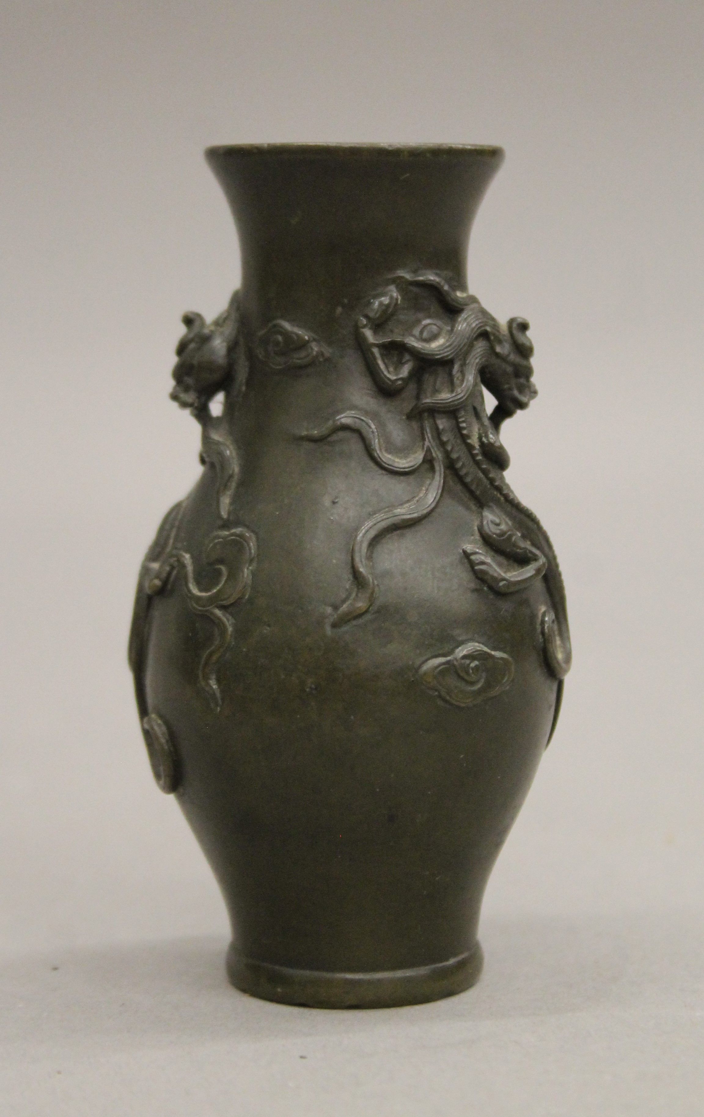 A small Chinese bronze vase decorated with dragons. 10 cm high. - Image 2 of 13