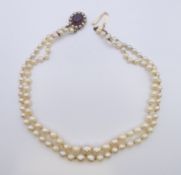 A double strand pearl choker with 9 ct gold amethyst and seed pearl clasp. 33 cm long.