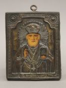 A small Russian icon of a Saint with metal oklad, circa 1900. 11 x 13.5 cm.