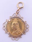 A Victorian double gold sovereign, dated 1887, set in a 9 ct gold mount. 24.8 grammes total weight.