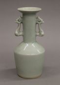 A celadon ground twin handled porcelain vase. 20.5 cm high.