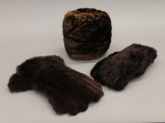 Two pairs of fur gloves and a muff.