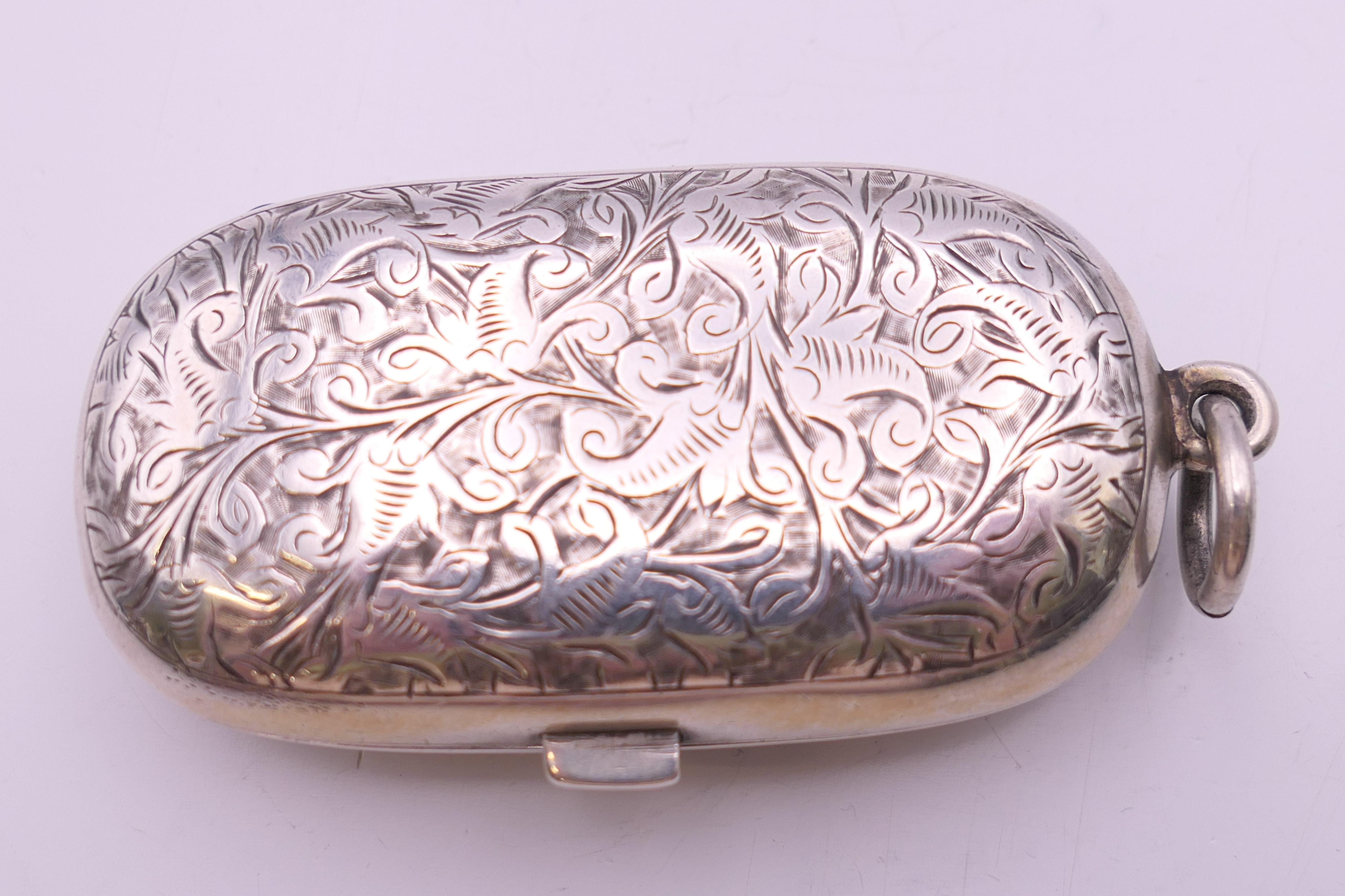 A Victorian silver sovereign case with leaf chased pattern, Birmingham 1886. 6 cm wide. 40 grammes. - Image 2 of 7