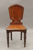 A Victorian mahogany hall chair. 48.5 cm wide.