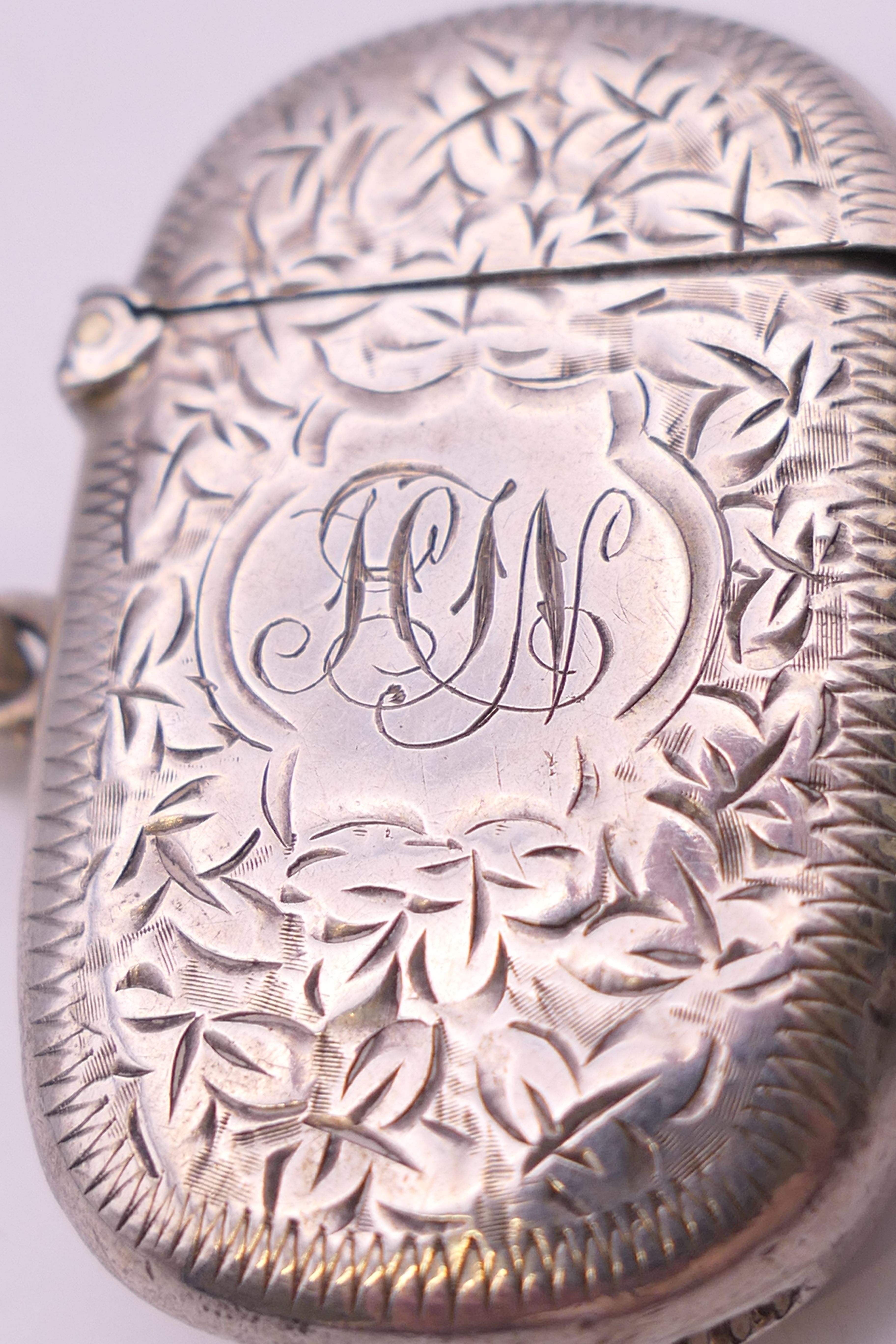 A Victorian silver vesta with leaf chased pattern, Birmingham 1898. 4 cm wide. 14.8 grammes. - Image 3 of 5