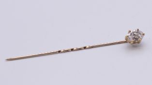 A 9 ct gold stick pin set with cubic zirconia. 1.1 grammes total weight.