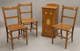 A Victorian scumble glazed pot cupboard and three chairs.