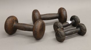 Two pairs of Victorian dumbbell weights. The largest 19 cm long.