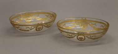 A pair of early 19th century bon bon dishes, with gilt decorated classical designs. Each 12 cm long.