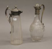 Two plate mounted glass claret jugs. The largest 27.5 cm high.