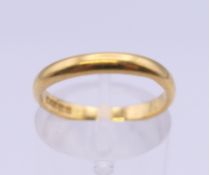 A 22 ct gold wedding band. Ring size L/M. 3.1 grammes.