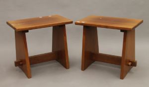 A pair of teak stools. 53 cm long.