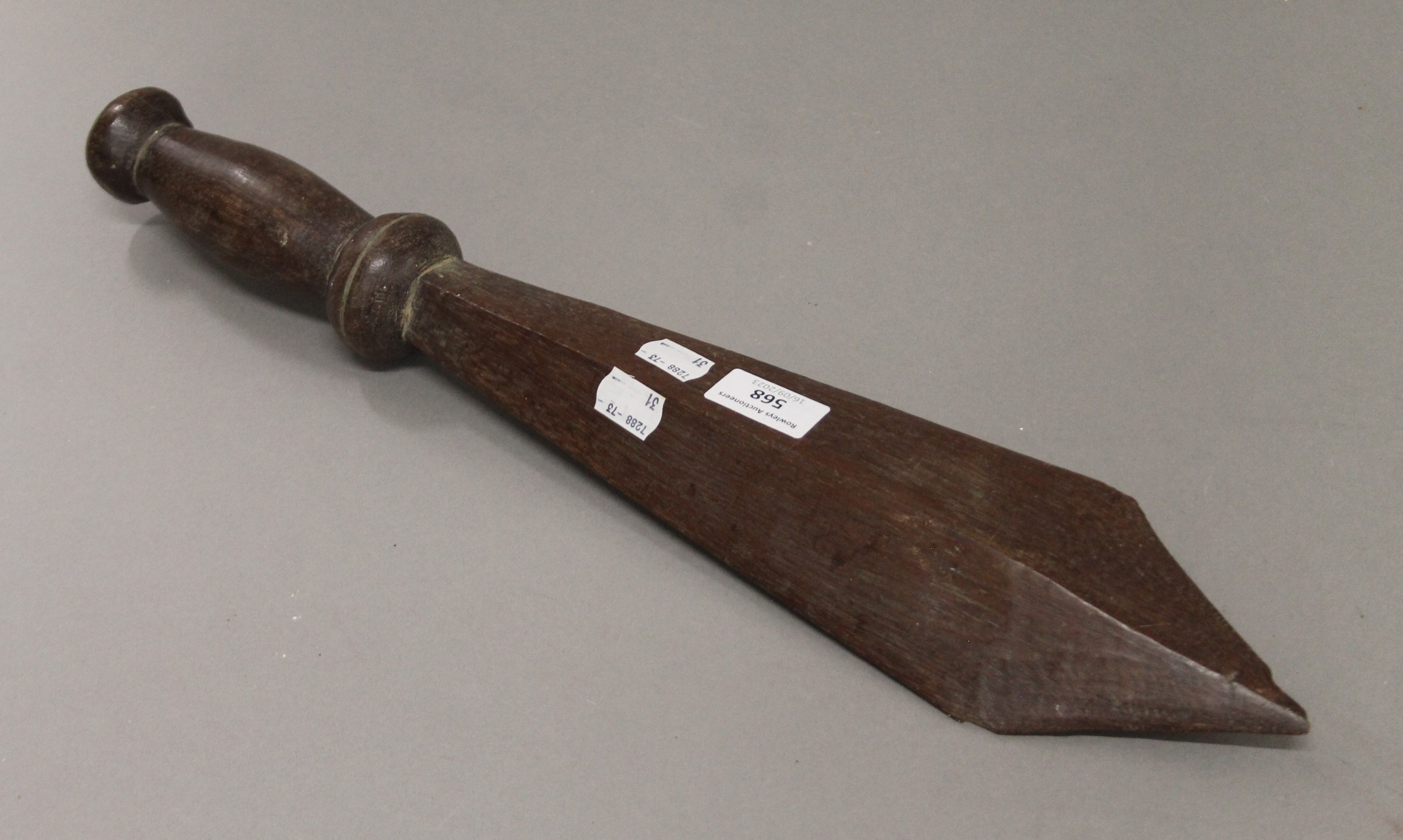 A tribal wooden sword form club, possibly South Seas. 51 cm long.