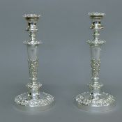 A pair of ornate silver plated candlesticks. 28 cm high.
