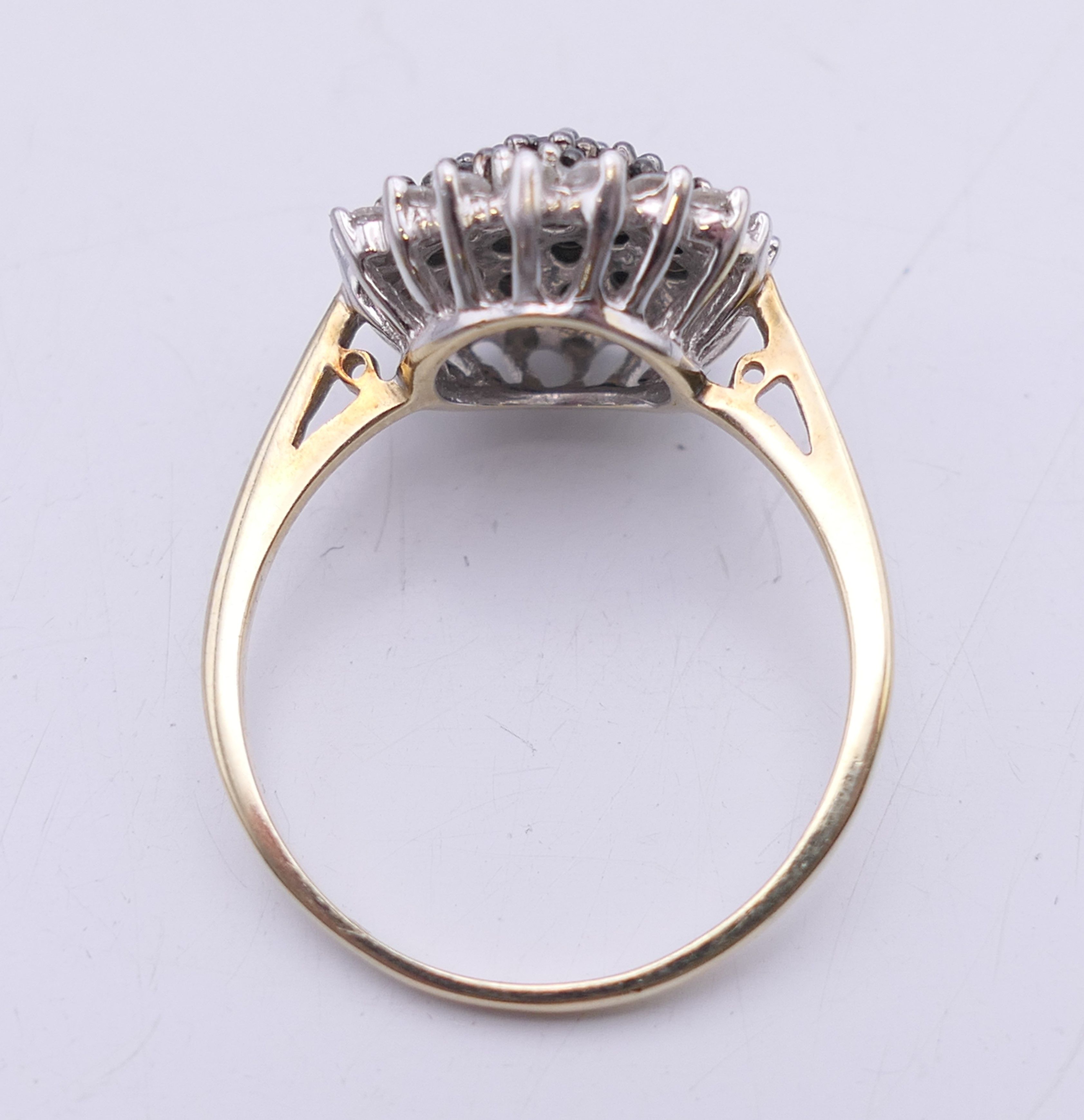 A 9 ct gold black and white diamond ring. 15 mm diameter. Ring size T/U. 4.1 grammes total weight. - Image 6 of 7