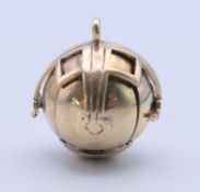 A 9 ct gold and silver Masonic ball fob, opening to form a cross. 2 cm high closed.