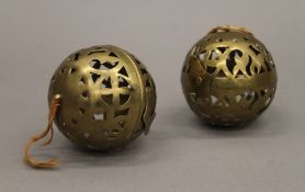 A pair of pierced brass incense burners. Each 7.5 cm high.