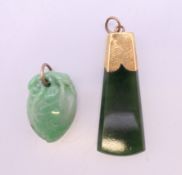 Two gold mounted jade pendants. The largest 4 cm high.