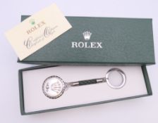 A key ring stamped Rolex in Rolex box, with certificate.