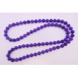 A lavender bead necklace. 70 cm long.