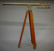 A brass telescope on tripod. 96 cm long.