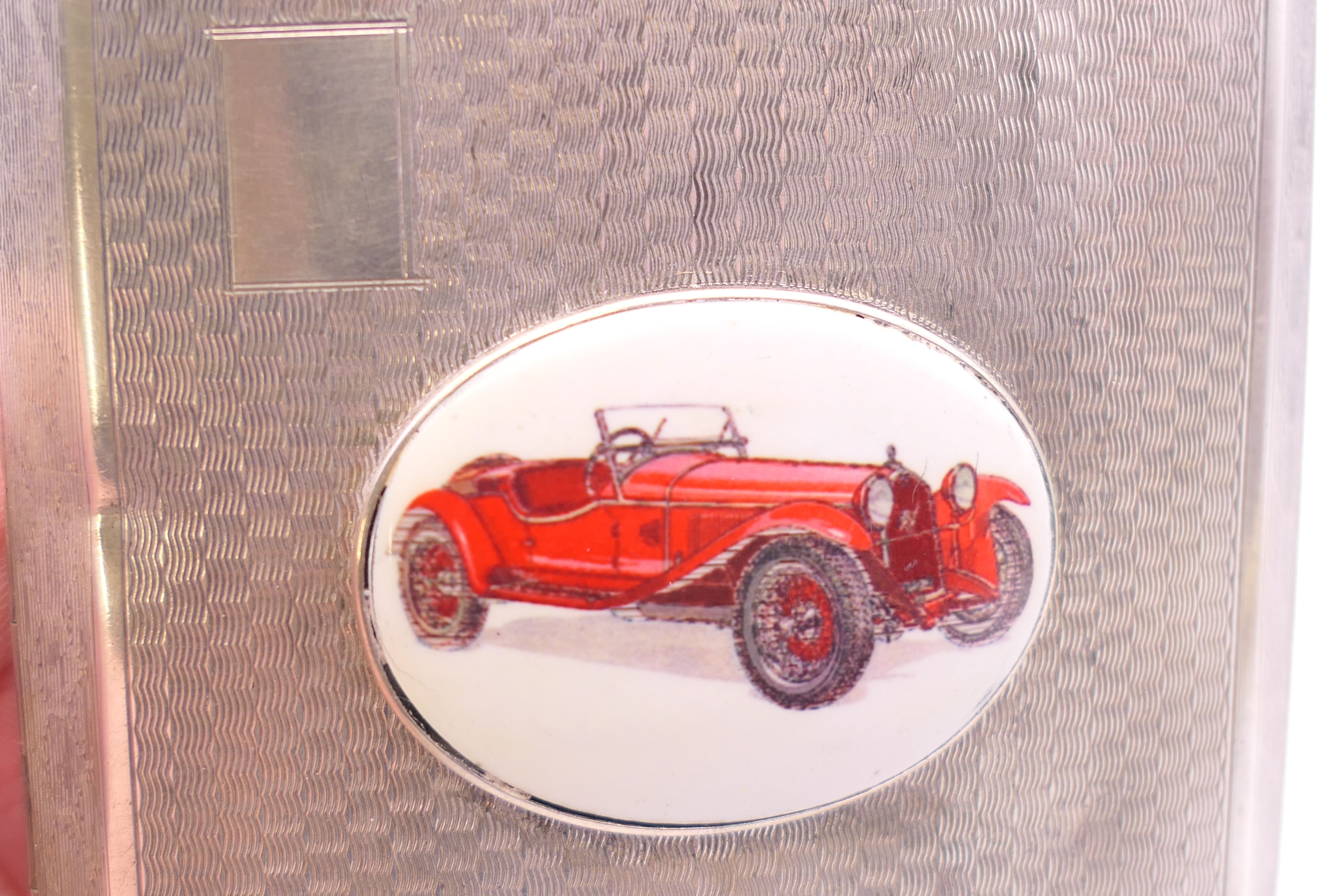 A silver enamel cigarette case decorated with a car. 8 cm wide. - Image 10 of 10