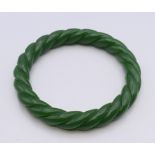 A green jade twist bangle. 5.5 cm inner diameter.
