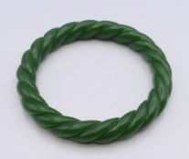A green jade twist bangle. 5.5 cm inner diameter.