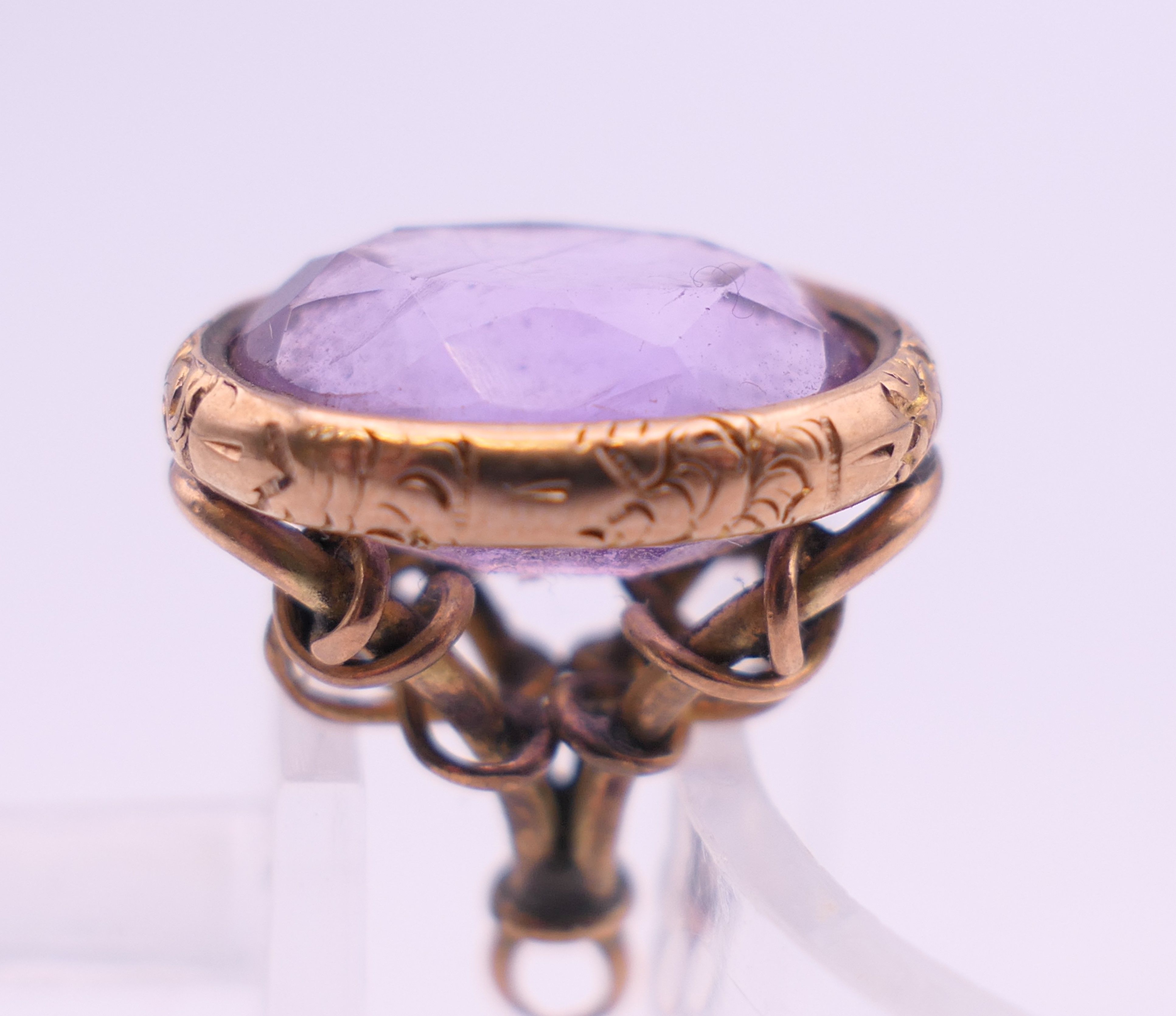 A 9 ct gold and amethyst rope design fob. 2 cm high. 5.2 grammes total weight. - Image 6 of 6