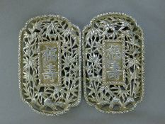 A Chinese silver buckle. 9 cm wide. 51 grammes.