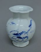 A Japanese blue and white vase decorated with crayfish. 19 cm high.