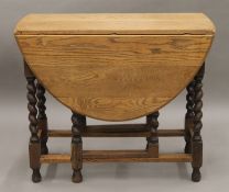 An early 20th century oak gate-leg table, an elm seated chair and a mirror. The table 90 cm long.