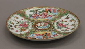 A 19th century Chinese Canton famille rose plate decorated with deities, butterflies,